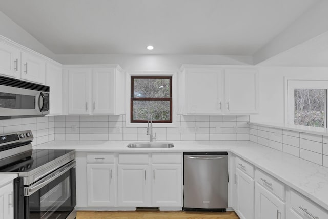 kitchen with white cabinets, stainless steel appliances, and sink