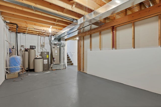 basement with electric water heater and heating unit