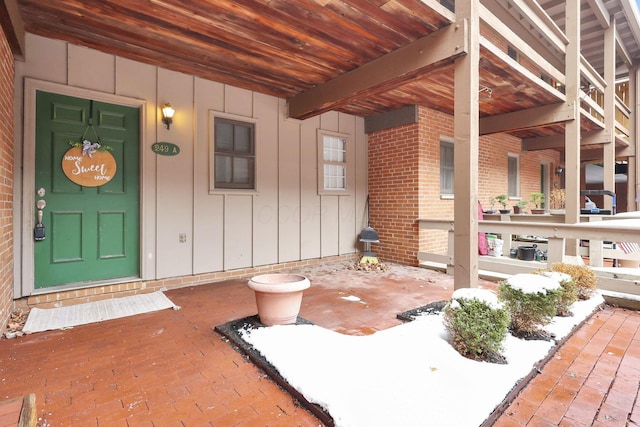 view of snow covered property entrance