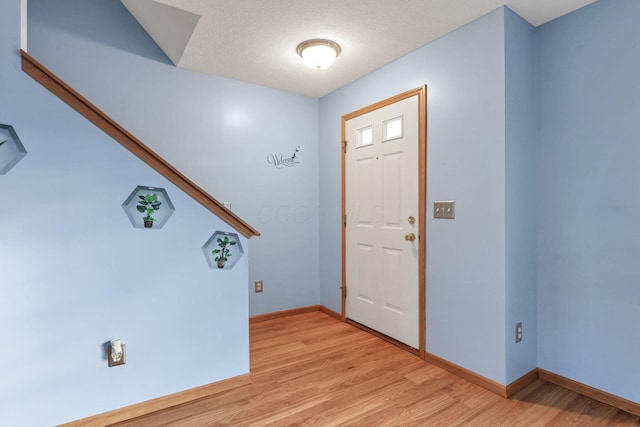 entrance foyer featuring light hardwood / wood-style flooring and a textured ceiling