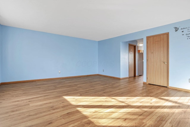 unfurnished room with light wood-type flooring