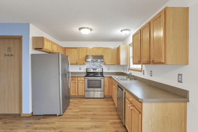 kitchen featuring sink, decorative backsplash, light wood-type flooring, light brown cabinetry, and stainless steel appliances