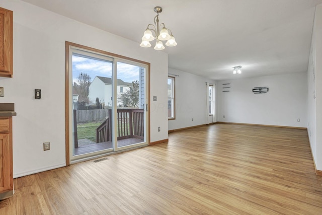 interior space featuring light hardwood / wood-style flooring and an inviting chandelier