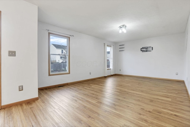 unfurnished room with light wood-type flooring