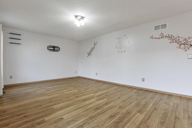 unfurnished room featuring light hardwood / wood-style flooring