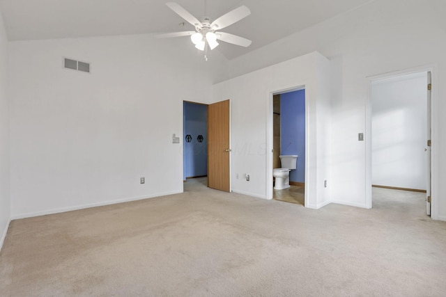 unfurnished bedroom with ensuite bathroom, ceiling fan, lofted ceiling, and light carpet