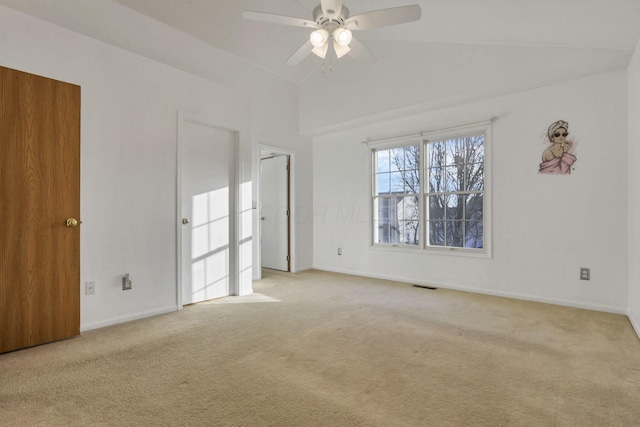 carpeted spare room featuring ceiling fan and lofted ceiling