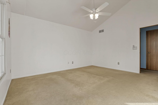 carpeted empty room featuring ceiling fan and high vaulted ceiling