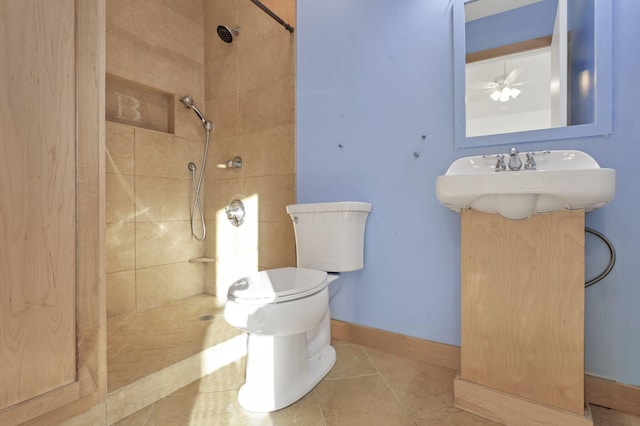 bathroom featuring tile patterned floors, ceiling fan, toilet, and tiled shower