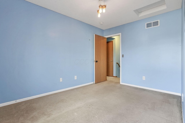 spare room featuring light colored carpet