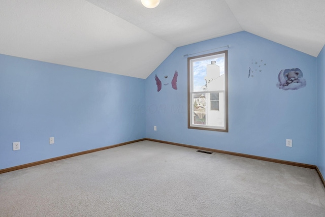 additional living space with carpet and lofted ceiling