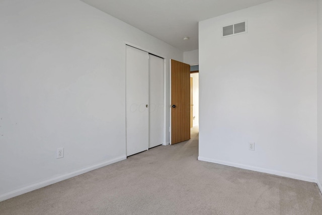 empty room featuring light colored carpet