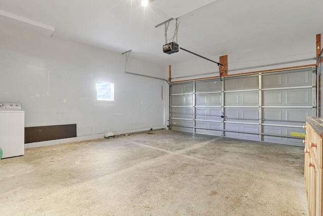 garage with washer / dryer and a garage door opener