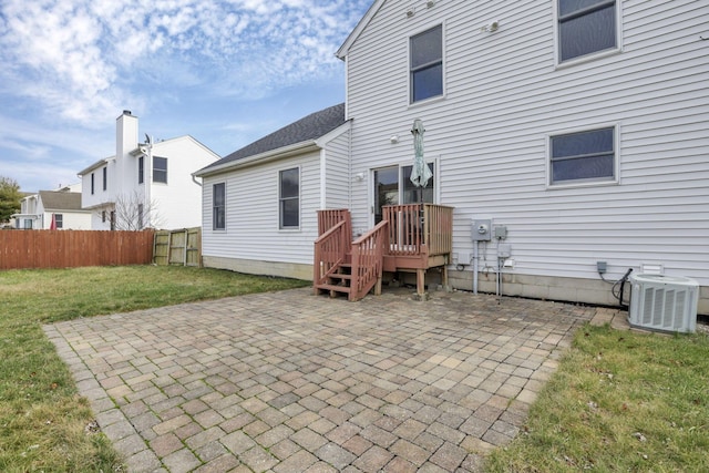 rear view of property featuring a yard, a patio area, and central air condition unit