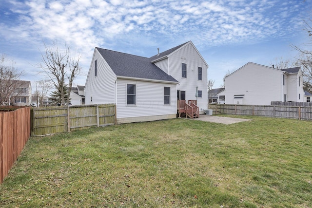 rear view of house featuring a lawn, a patio area, and a deck