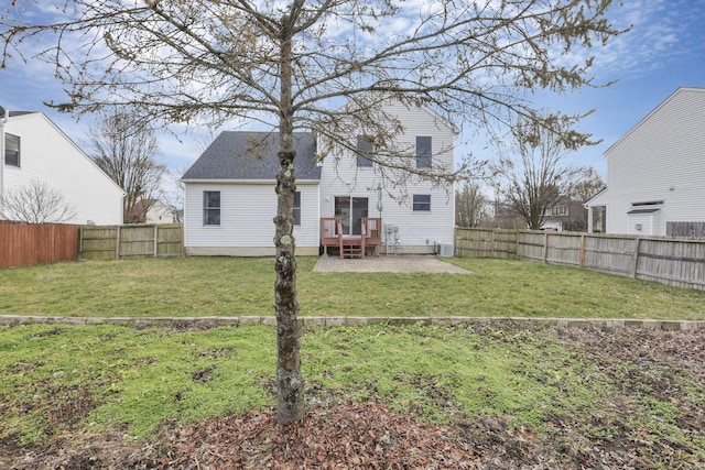 rear view of property featuring a lawn and a patio area