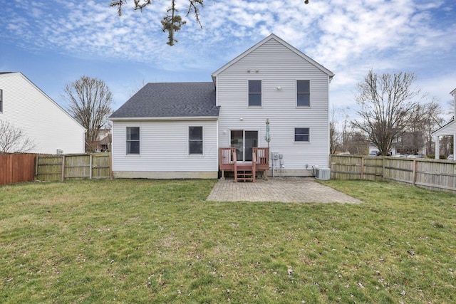 back of property with central AC, a patio area, a yard, and a wooden deck