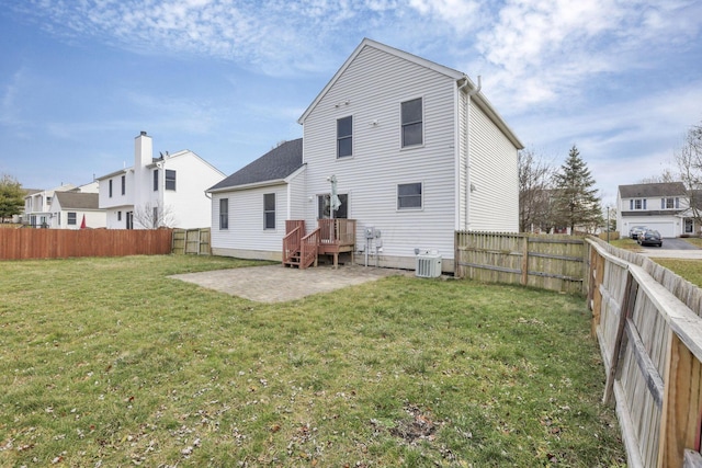 back of property featuring cooling unit, a patio area, and a lawn