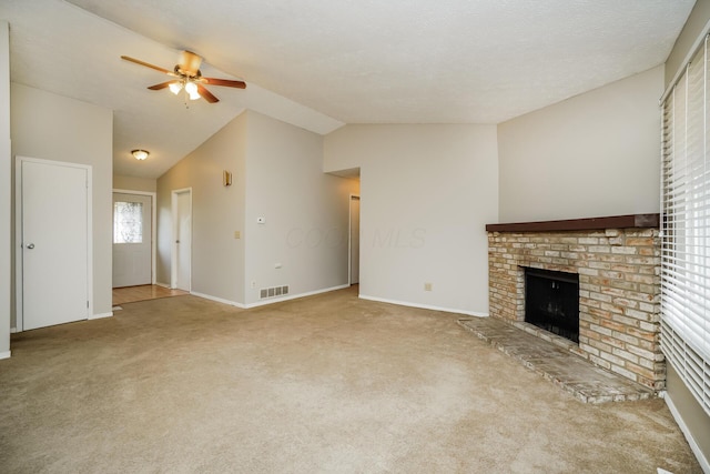 unfurnished living room with a fireplace, light colored carpet, ceiling fan, and vaulted ceiling