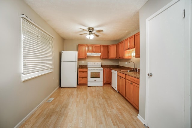 kitchen featuring ceiling fan, sink, white appliances, and light hardwood / wood-style flooring