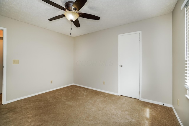 unfurnished room with ceiling fan and a textured ceiling