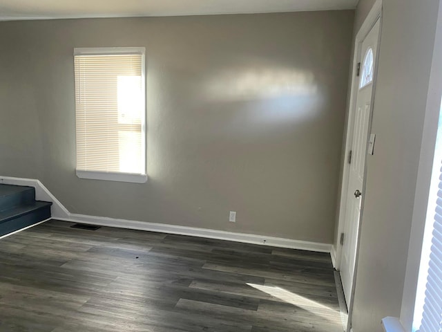 unfurnished room featuring dark wood-type flooring