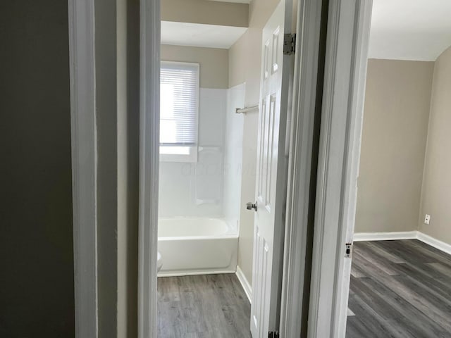 bathroom featuring hardwood / wood-style floors and shower / bath combination