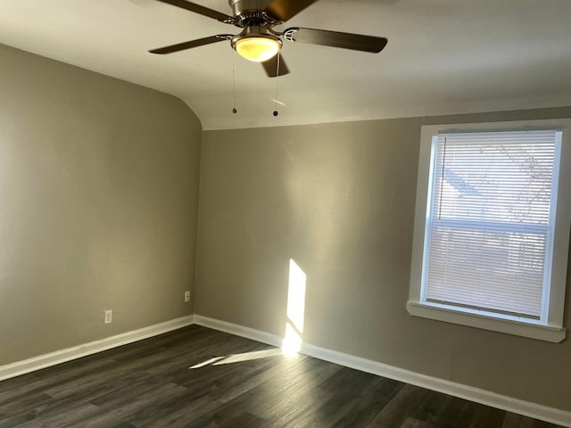 unfurnished room featuring ceiling fan, dark hardwood / wood-style flooring, and vaulted ceiling