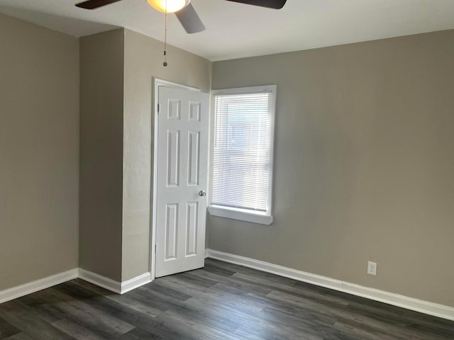 unfurnished bedroom featuring dark hardwood / wood-style flooring, a closet, and ceiling fan