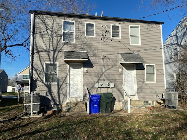 back of property featuring central AC