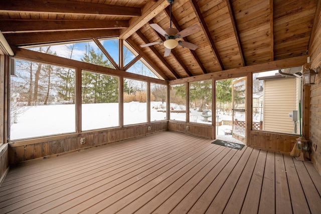 unfurnished sunroom featuring ceiling fan, wood ceiling, and vaulted ceiling with beams