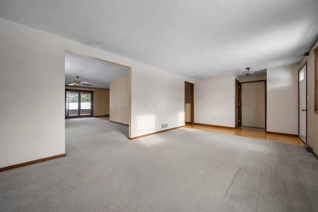 empty room with light colored carpet and ceiling fan