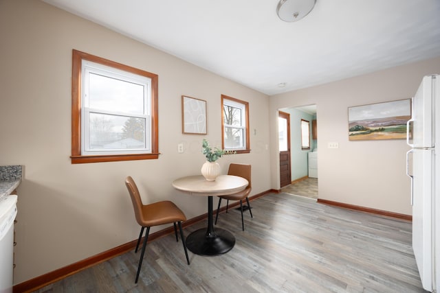 dining space with light wood-type flooring