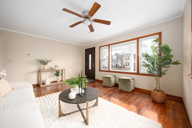 living room featuring ceiling fan, wood-type flooring, and ornamental molding