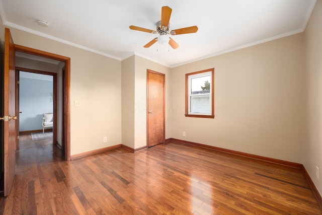 unfurnished bedroom with crown molding, a closet, ceiling fan, and dark wood-type flooring