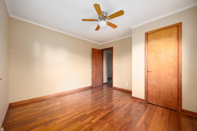 unfurnished bedroom with ceiling fan, crown molding, and dark hardwood / wood-style floors