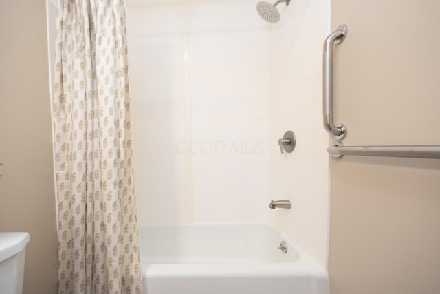 bathroom featuring shower / bath combination with curtain and toilet