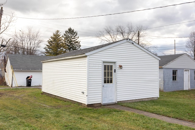 view of outbuilding with a lawn