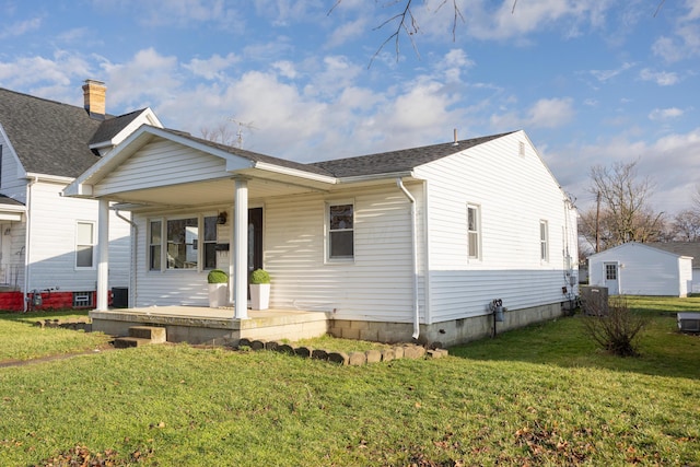 view of front of house with a porch and a front lawn