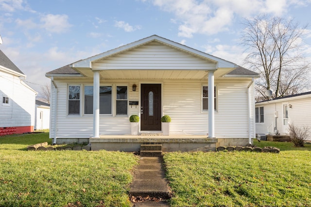 bungalow featuring a front lawn and a porch