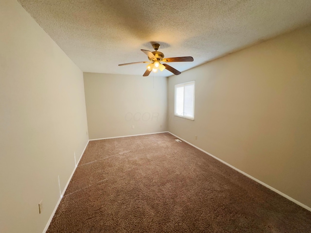 spare room featuring carpet, a textured ceiling, and ceiling fan