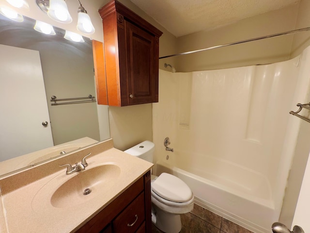 full bathroom with shower / bathtub combination, vanity, a textured ceiling, tile patterned flooring, and toilet