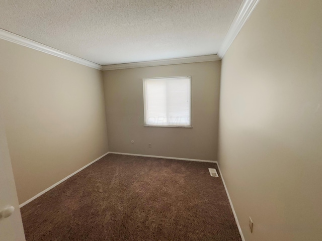 empty room with dark colored carpet, ornamental molding, and a textured ceiling