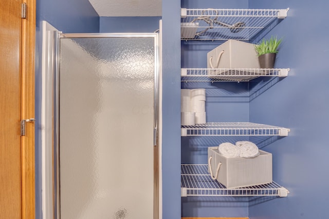 bathroom featuring a textured ceiling and walk in shower