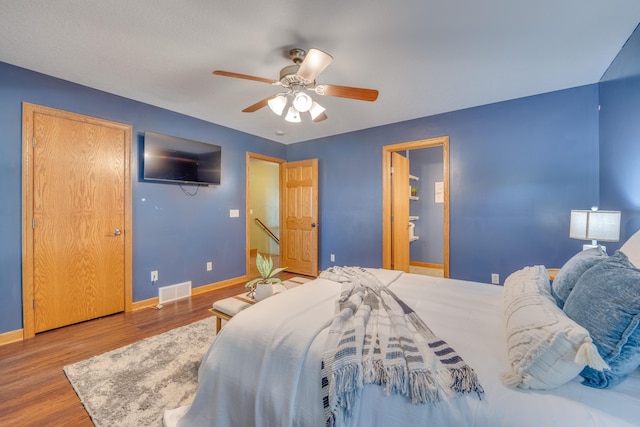 bedroom with hardwood / wood-style flooring and ceiling fan