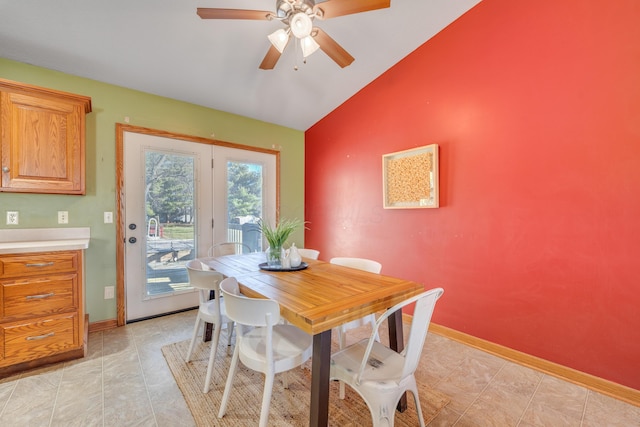 dining area with vaulted ceiling, ceiling fan, and light tile patterned flooring