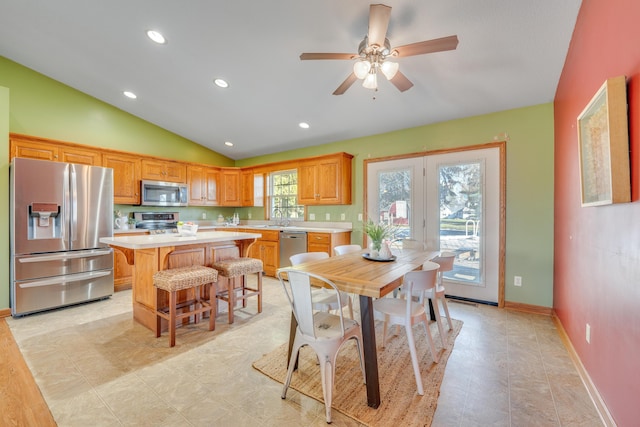 dining room featuring ceiling fan, lofted ceiling, and sink