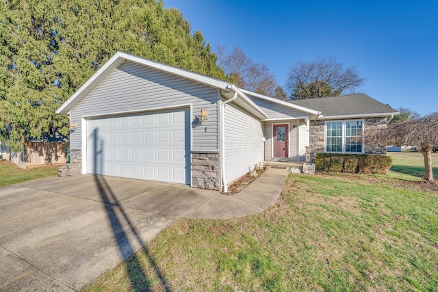 ranch-style house featuring a garage and a front lawn