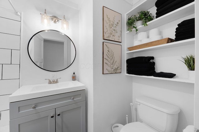 bathroom featuring vanity and toilet