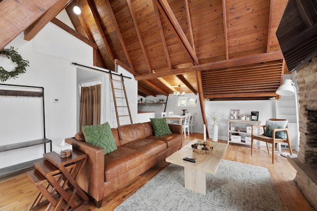 living room featuring hardwood / wood-style floors, a barn door, lofted ceiling with beams, and wooden ceiling